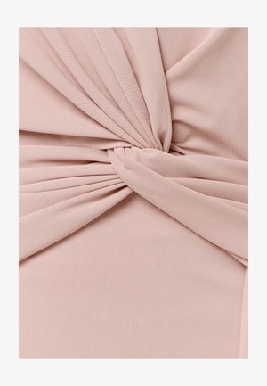 Soft pink fabric twisted into a smooth knot with subtle ribbed texture and folds radiating from the center.
