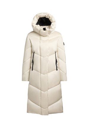 Manteau matelassé long de couleur crème avec un motif en chevrons, un col haut et deux poches latérales zippées noires. Fini lisse et brillant.