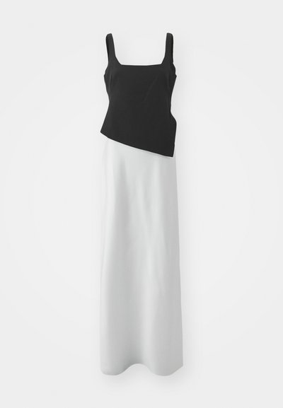Top negru fără mâneci cu decolteu pătrat, combinat cu o fustă lungă albă, materiale contrastante și design asimetric. Textură netedă.