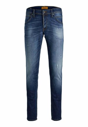 Jeans in denim con un lavaggio medio, con lievi segni di usura, vestibilità affusolata, cinque tasche e dettagli di cucitura in contrasto.