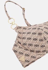 Braided fabric bikini top in light beige with black logo pattern, featuring gold-tone hardware and triangular brand tag on the side.