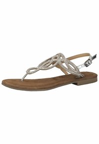 Zilveren platte teensandalen met een decoratief gevlochten bandontwerp en een tan kleurige faux suede voetbed. Verstelbare enkelband voor een veilige pasvorm.