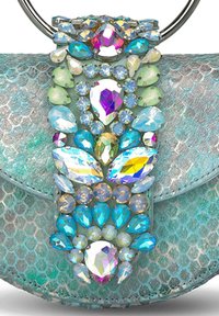 Bolso de piel de serpiente en color verde azulado con un mango de anillo metálico, que presenta una decoración de piedras preciosas en tonos de azul, verde y acentos iridiscentes.