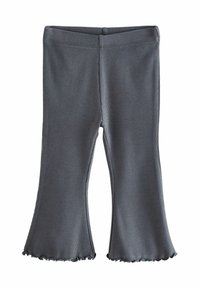 Leggings gris clair à rayures avec un ourlet volan. Le tissu est extensible, offrant une silhouette ajustée et un port confortable.