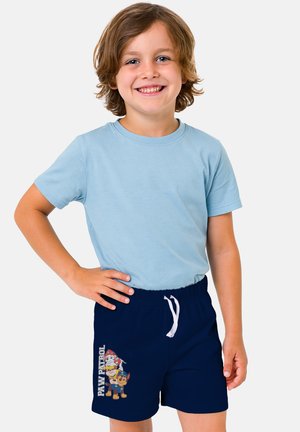 Blue short-sleeve shirt and navy swim shorts with a white drawstring, featuring a colorful "Paw Patrol" graphic on the left leg.