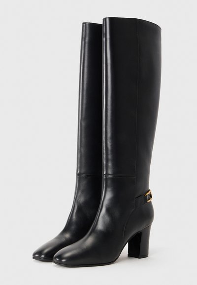 Knee-high black leather boots with a smooth finish, square toes, and block heels; features a decorative gold buckle and stitching detail.