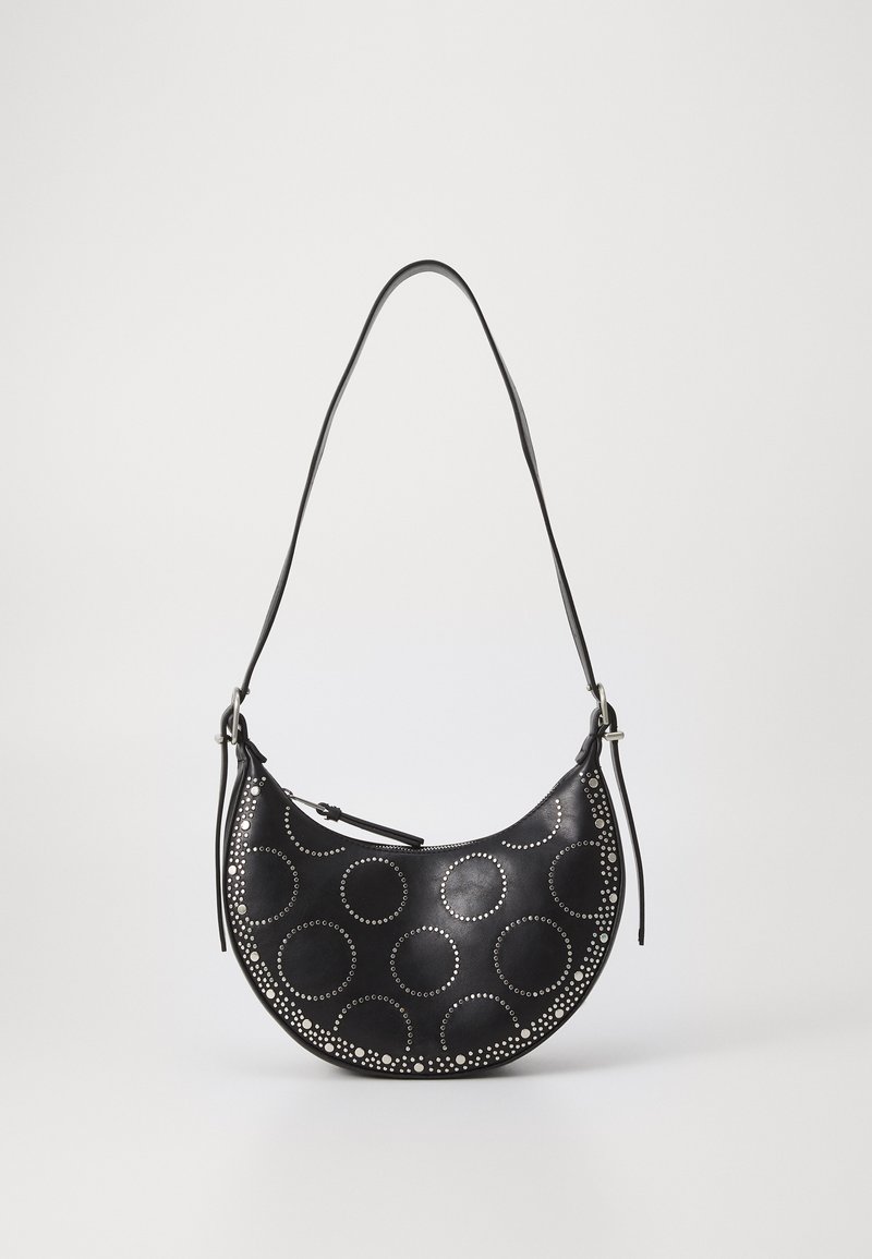 Black leather handbag with a curved shape, featuring circular cutouts and silver studs. Includes a single adjustable strap.