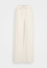 Wide-leg pants in off-white cotton fabric, featuring an elastic waistband with a drawstring and side pockets. Smooth texture, minimal design.