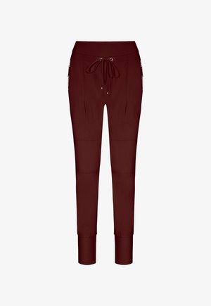 Burgundy jogger pants made from a smooth fabric, featuring a drawstring waist, side pockets, and tapered cuffs.
