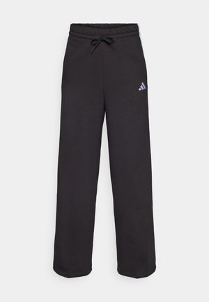 Pantalons de sport noirs avec une taille élastique et un cordon de serrage, fabriqués en tissu doux. Présente un petit logo Adidas blanc sur le côté gauche.