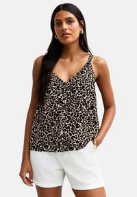 Top sans manches en imprimé léopard avec un décolleté en V et un devant à boutons. Tissu léger avec des taches noires et brunes sur un fond beige.