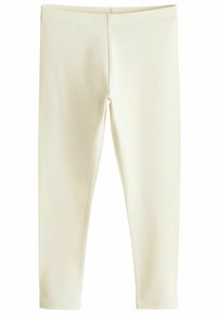 Leggings de couleur crème en tissu doux et extensible ; présentent une texture lisse et une coupe ajustée avec une taille élastique.