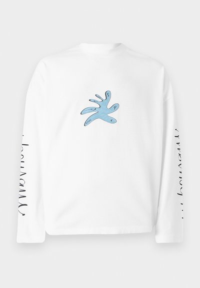 White long-sleeve t-shirt featuring a blue abstract hand design on the front and text along the left sleeve. Soft cotton material.