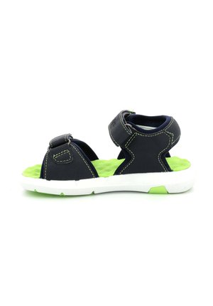Sandalias sintéticas en negro y verde con correas ajustables, una plantilla verde texturizada y una suela de goma blanca con un acento verde.