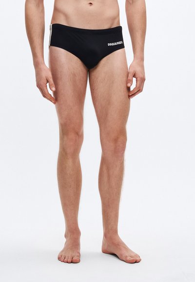 Black swim briefs made of smooth material, featuring a contrasting logo on the front and side stripes in a lighter shade.