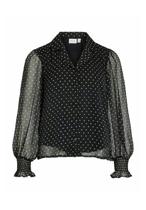 Sort skjortebluse med polkaprikket mønster, gennemsigtige puffede ærmer og smockmanchetter. Har en klassisk krave og let materiale.