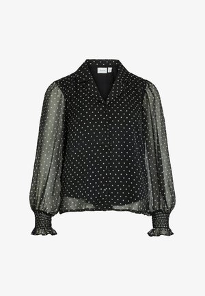 Czarna bluzka zapinana na guziki w kropki, z przezroczystymi bufkami na rękawach i marszczonymi mankietami. Posiada klasyczny kołnierzyk i lekką tkaninę.