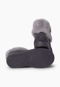 Botas de tobillo de ante gris con un suave ribete de piel sintética gris, suelas de goma con patrón de zigzag y un detalle de correa lateral.