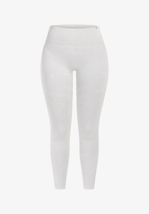 Leggings de color gris claro con una cinturilla alta, diseño sin costuras y patrones texturizados sutiles a lo largo de las piernas. Fabricadas con tejido elástico.