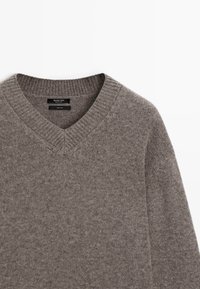 Szary sweter wełniany w serek z prążkowanym kołnierzem i długimi rękawami, oznaczony marką Massimo Dutti.
