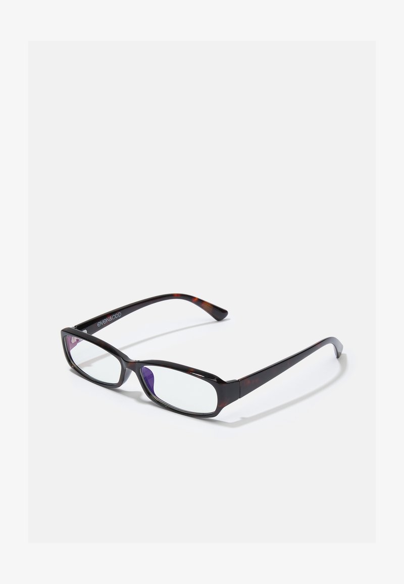 Ochelari dreptunghiulari din tortoiseshell maro cu lentile clare. Brațe subțiri, netede și o ușoară curbă la tâmple. Numele mărcii pe braț.