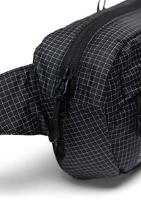 Black fabric waist bag with a grid pattern, featuring a zipper closure, adjustable strap, and textured surface.