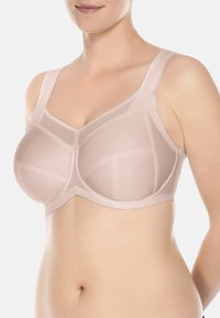 Beige onderkleding beha met netpanelen, gladde stof en brede verstelbare bandjes, ontworpen voor comfort en ondersteuning.