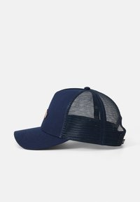 Gorra de béisbol azul marino con un frente sólido y parte trasera de malla. Presenta un visera curvada y un logotipo bordado en la parte delantera. Correa ajustable en la parte posterior.