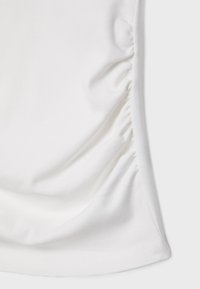 White fabric with gathered detailing along the side, smooth texture, slightly stretchy, and curved hemline at the bottom.