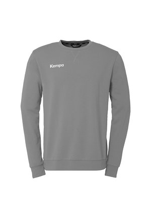 Grå sweatshirt lavet af bomuldsblanding. Har lange ærmer, rund hals og et hvidt "Kempa" logo på brystet. Glat tekstur, minimalistisk design.
