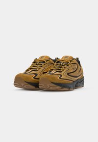 Brown suede and synthetic sneakers with black accents, textured rubber sole, and durable laces. Features a logo at the tongue and side panels.