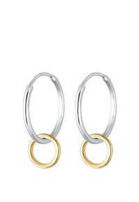 Boucles d'oreilles en argent en forme de créole avec un petit accent en or attaché à chaque créole. Fini métallique lisse, forme circulaire et texture polie.