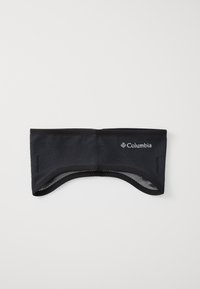 Panta kepala fleece hitam dengan sisi yang memiliki tekstur, bagian belakang yang dapat bernapas, dan logo Columbia di depan. Bahan yang halus dan elastis.