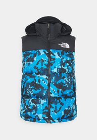 Prošívaná vesta s kapucí, nahoře černá část a dole modro-černý maskáčový vzor, zapínání na zip a logo The North Face.