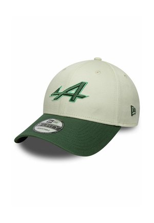 Baseball cap with light beige crown and dark green curved brim, featuring green embroidered stylized "A" on front and New Era logo on side.