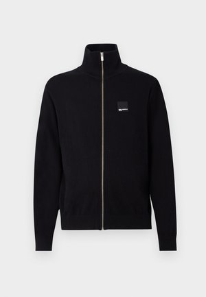 Black full-zip cardigan with high collar, ribbed cuffs and hem, and a small square brand logo patch on the left chest.