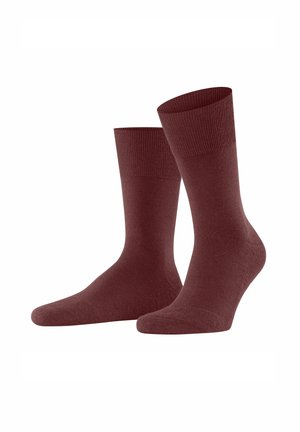 Maroon socks with ribbed cuffs, positioned upright on a white background, showcasing their smooth texture and design.