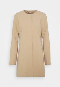 Cappotto beige con scollatura rotonda, maniche lunghe e due tasche frontali. Presenta una silhouette dritta e un tessuto leggermente strutturato.
