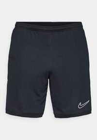 Pantaloni sportivi neri caratterizzati da un tessuto leggero e morbido, cintura elastica e un accento con il logo Nike bianco vicino all'orlo.