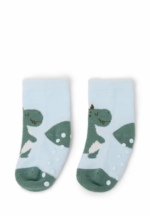 Calzini alla caviglia blu chiaro con un motivo di dinosauro verde e dettagli bianchi, dotati di punti di presa testurizzati sulle suole per una maggiore aderenza.
