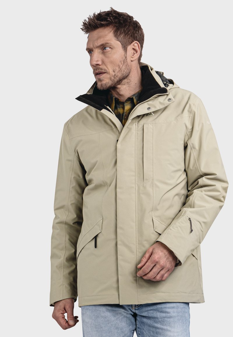 Beige wasserfeste Jacke mit einem Reißverschluss an der Vorderseite, verstellbarer Kapuze und zwei seitlichen Taschen. Besondere Merkmale sind die strukturierte Oberfläche und der kontrastierende schwarze Kragen.
