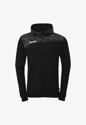 Black full-zip jacket with hood, geometric pattern on shoulders, and white "Kempa" logo on left chest.