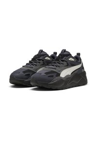 Sneakers featuring a black mesh and synthetic upper with gray accents, textured sole, and a prominent white stripe on the side.