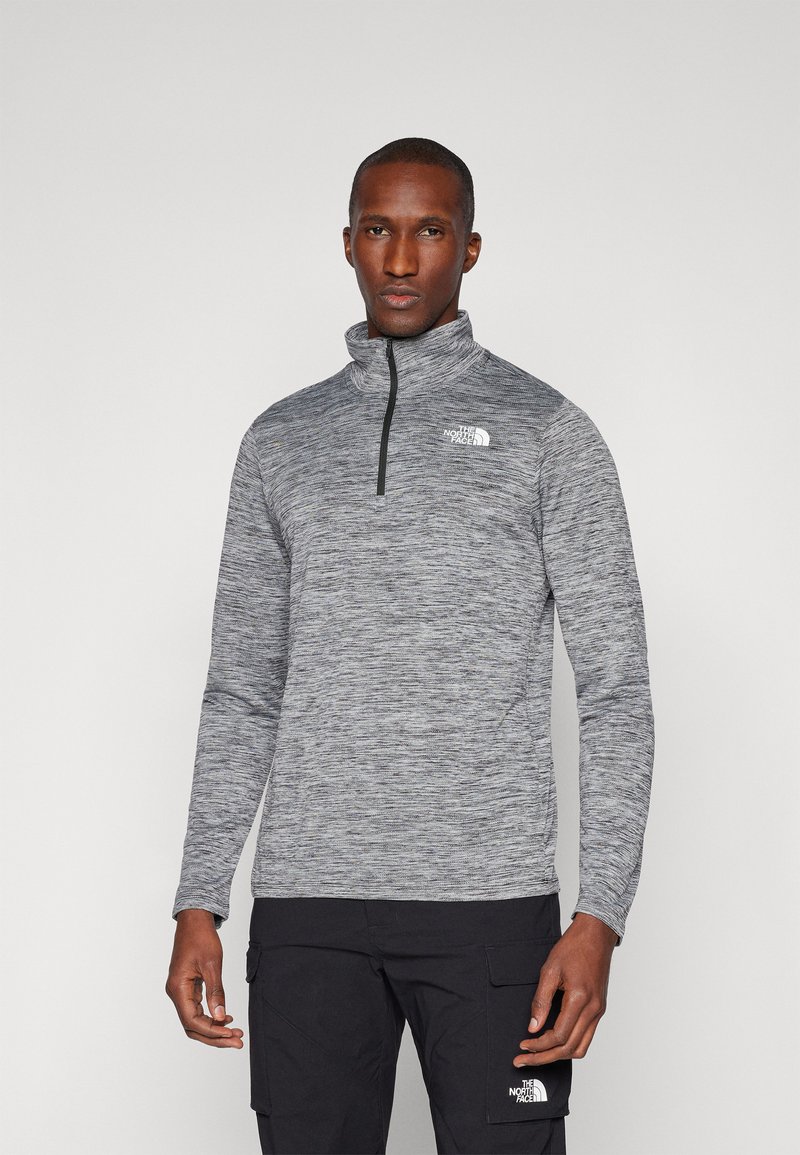 Pullover a mezzo zip in tessuto grigio mélange con maniche lunghe. Presenta un col alto e un logo bianco sul lato sinistro del petto.