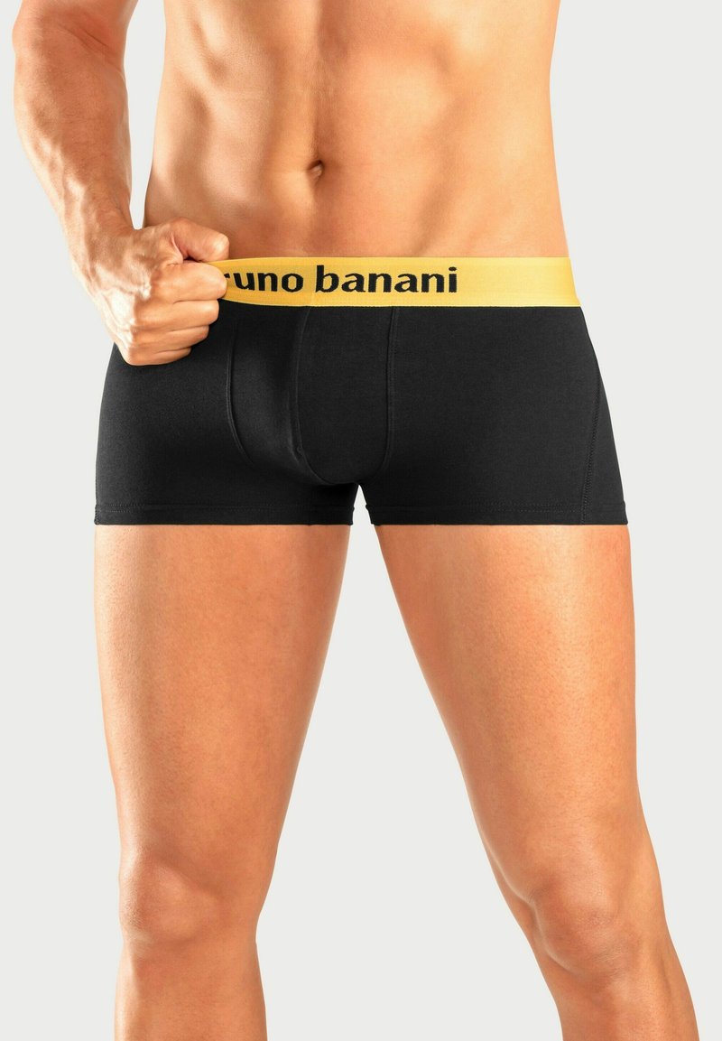 Musta bokseritrikoot keltaisella vyötärönauhalla, jossa on "bruno banani" -logo. Valmistettu pehmeästä kankaasta, sopii hyvin päälle ja kestävällä ompeleella.