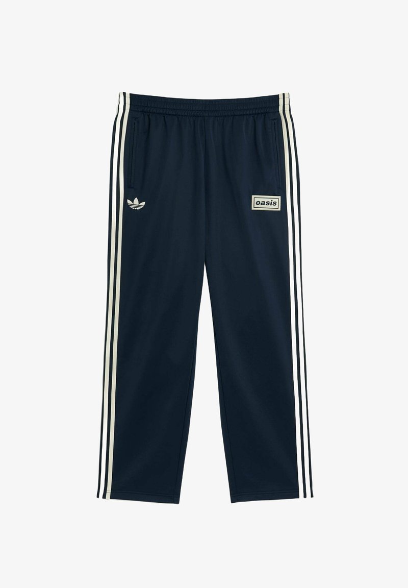 Navy track pants in a lightweight fabric, featuring three white stripes along the sides and a small "oasis" logo on the front.