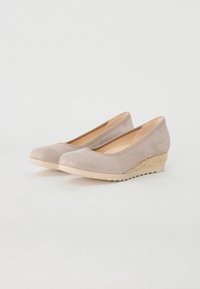 Beige wedge shoes made of textured material, featuring a rounded toe and a woven straw accent on the wedge heel. Smooth interior lining.