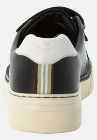 Black leather sneaker with white heel, beige sole, and three vertical striped accents in olive green and brown on the back.