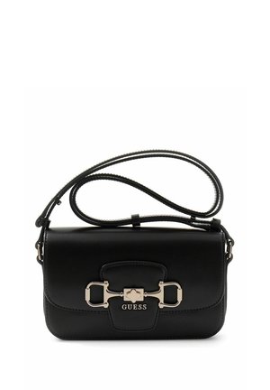 Black Guess shoulder bag with gold-tone hardware and adjustable strap, featuring a front clasp and logo detailing.