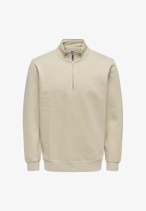 Beige long-sleeve pullover with a stand collar and front half-zip closure, ribbed cuffs, and hem.